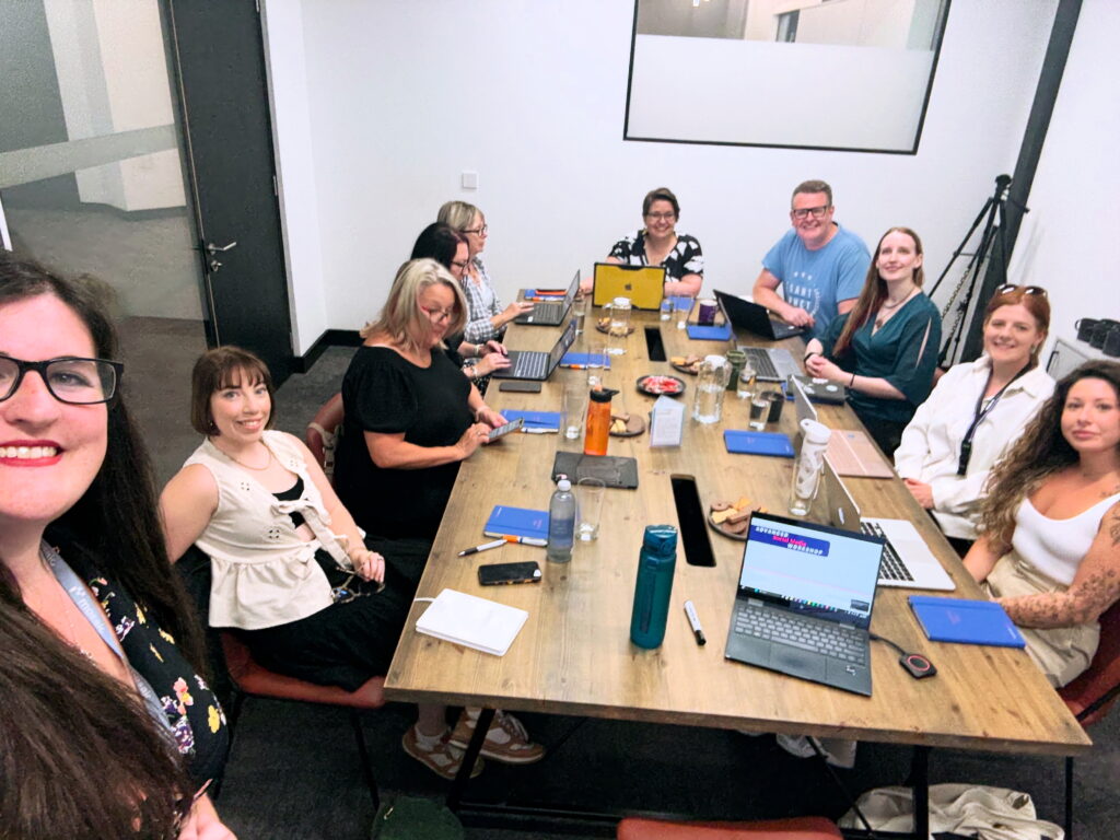 9 workshop attendees sat round a table at one of Arcanum Academy's workshops.