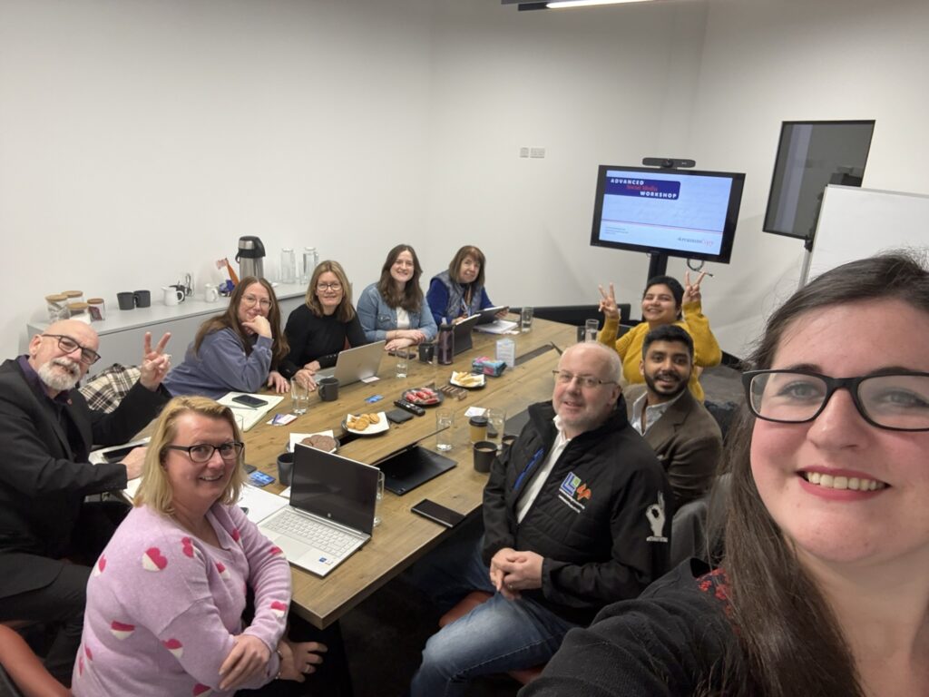 10 workshop attendees sat round a table at one of Arcanum Academy's workshops.