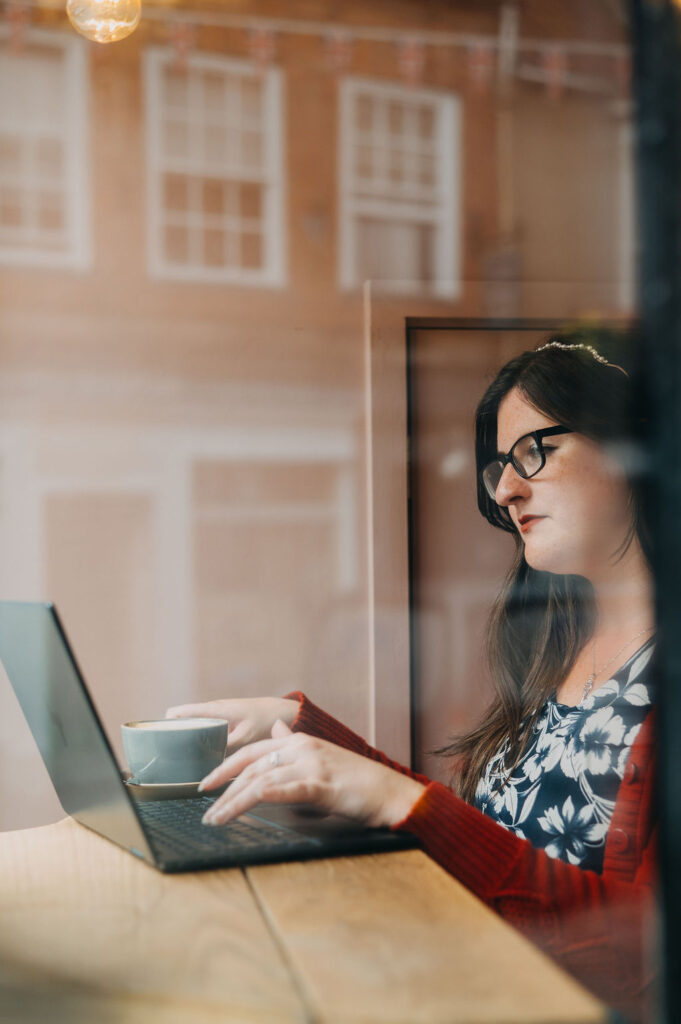 Eleanor Bryan sat at her laptop in a coffee shop. She is focused on work.