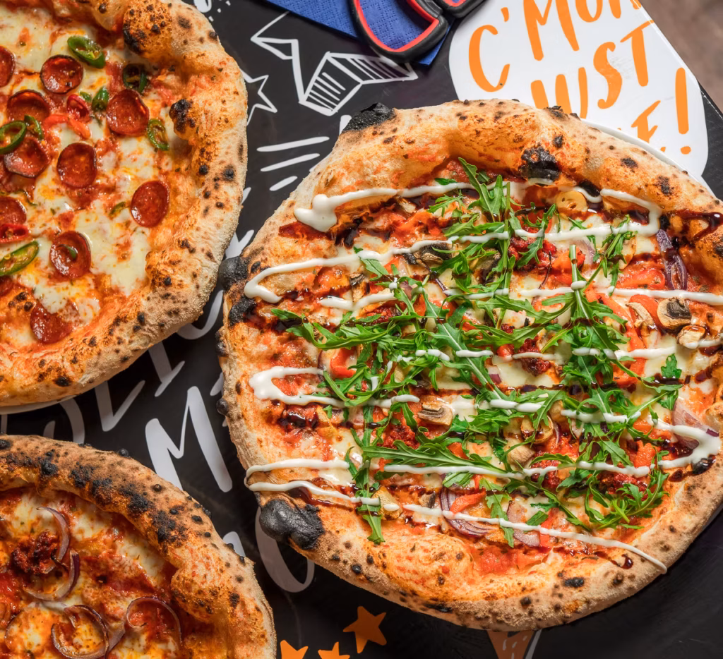 Three delicious pizzas from Dough Loco pizza rstaurant.