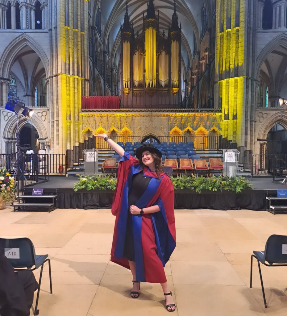 Eleanor Bryan stood in Lincoln Cathedral at her PhD graduation.