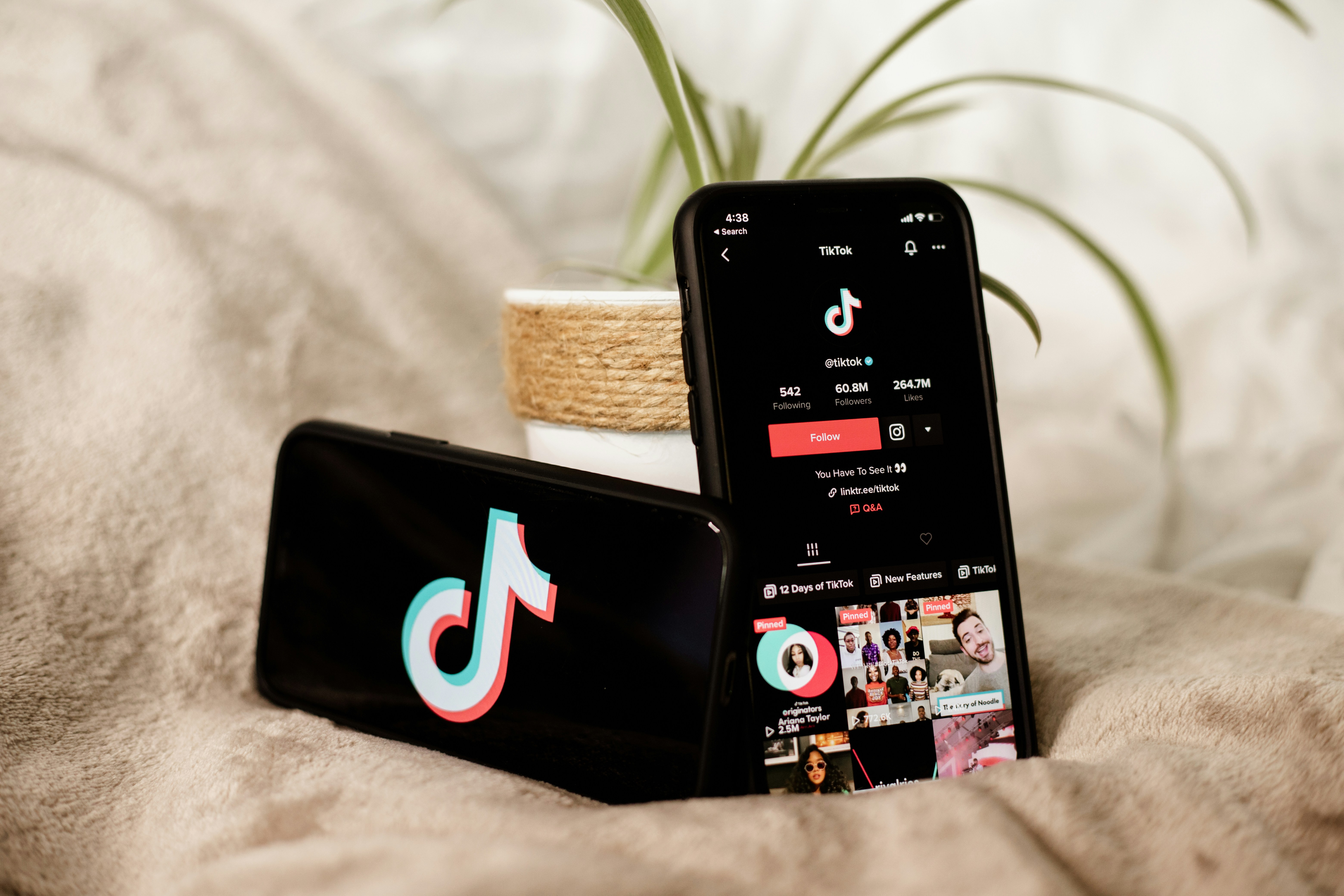 Two phones with the TikTok logo on the screen.